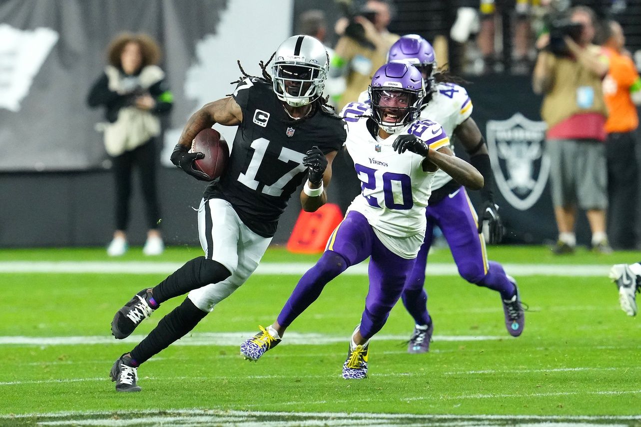 Las Vegas Raiders wide receiver Davante Adams (17) gains yards ahead of Minnesota Vikings safety Jay Ward (20) during the final seconds of the fourth quarter at Allegiant Stadium.