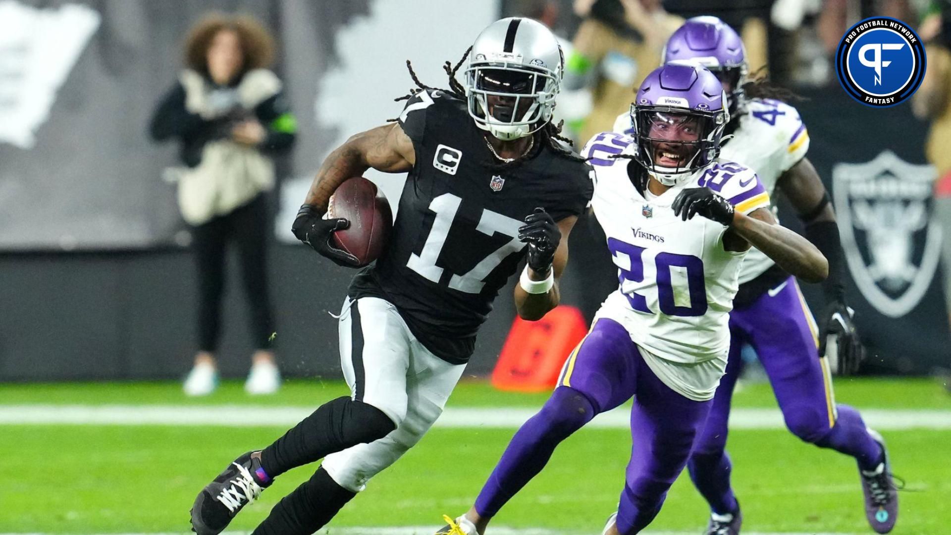 Las Vegas Raiders wide receiver Davante Adams (17) gains yards ahead of Minnesota Vikings safety Jay Ward (20) during the final seconds of the fourth quarter at Allegiant Stadium.