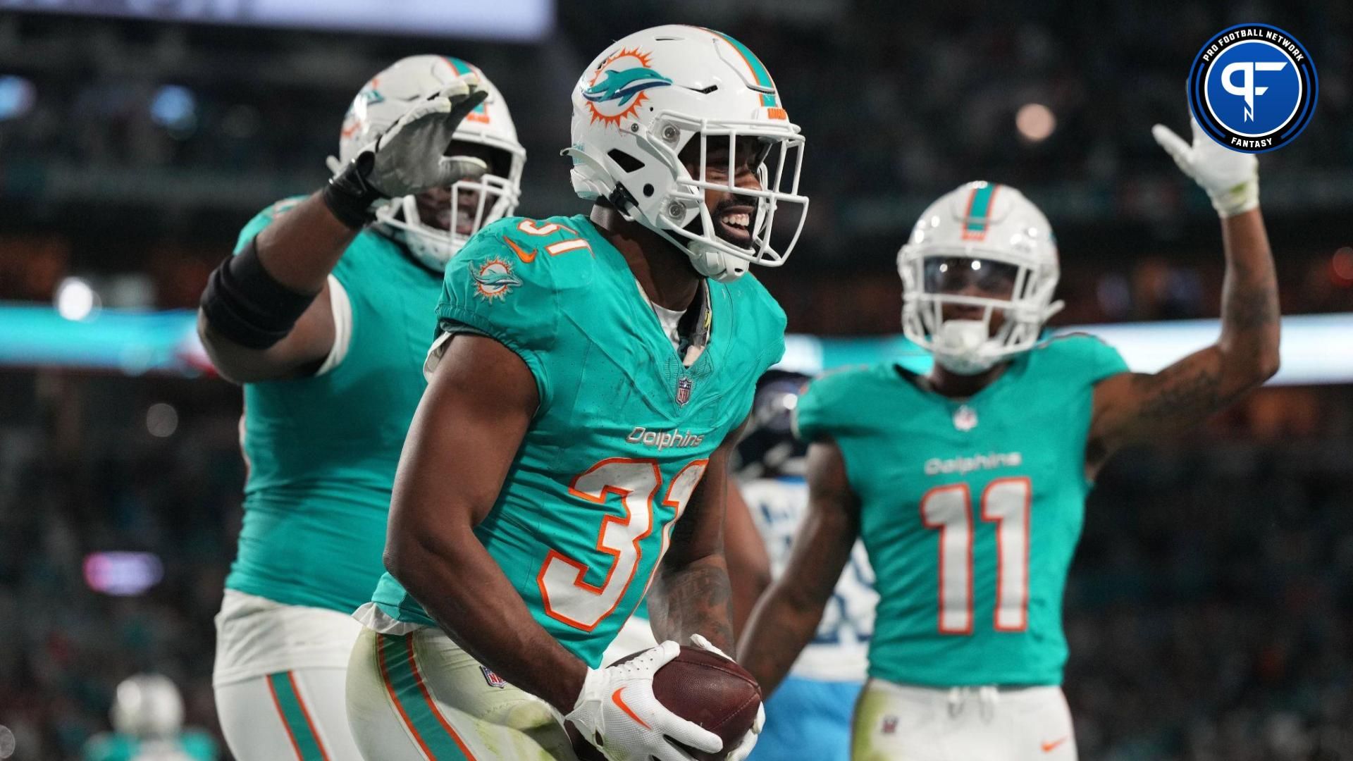 Miami Dolphins running back Raheem Mostert (31) celebrates scoring a touchdown against the Tennessee Titans during the second half of an NFL game at Hard Rock Stadium.