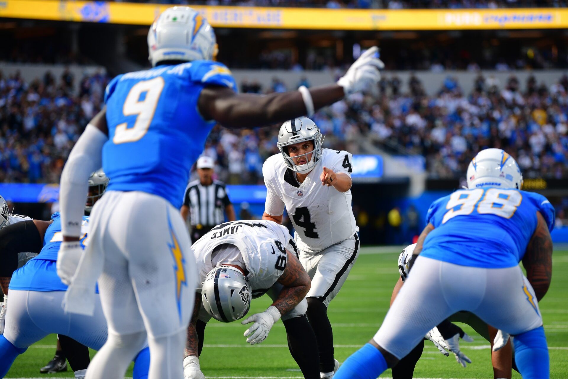 Las Vegas Raiders quarterback Aidan O'Connell (4) scans the line of scrimmage against the Los Angeles Chargers during the second half at SoFi Stadium.