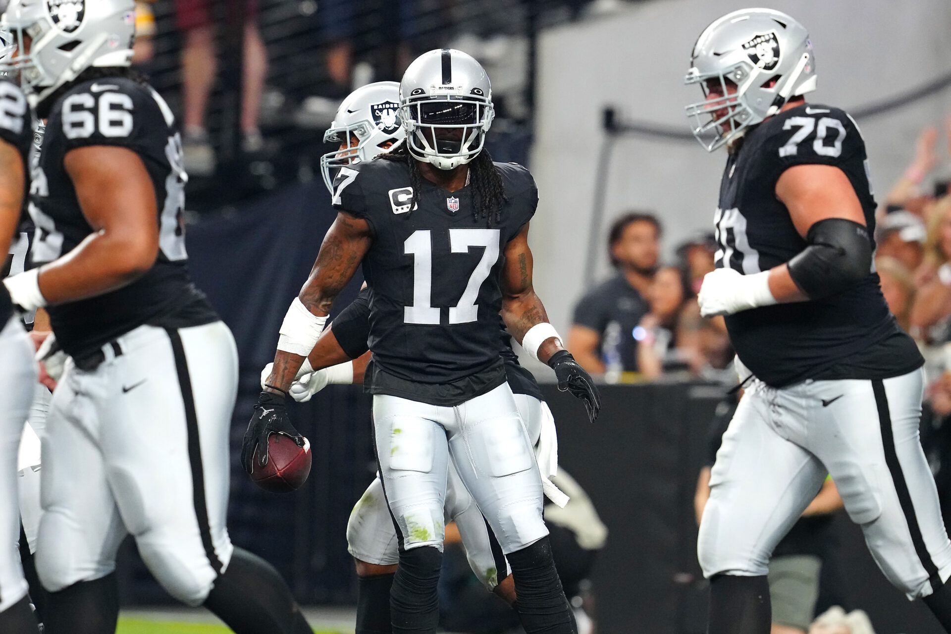 Las Vegas Raiders wide receiver Davante Adams (17) celebrates after scoring a touchdown against the Pittsburgh Steelers during the first quarter at Allegiant Stadium.