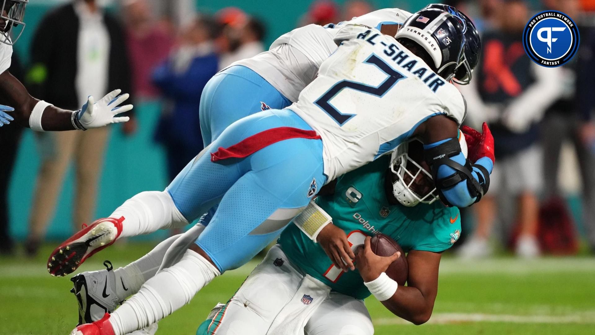 Tennessee Titans linebacker Azeez Al-Shaair (2) tackles Miami Dolphins quarterback Tua Tagovailoa (1) during the second half at Hard Rock Stadium.