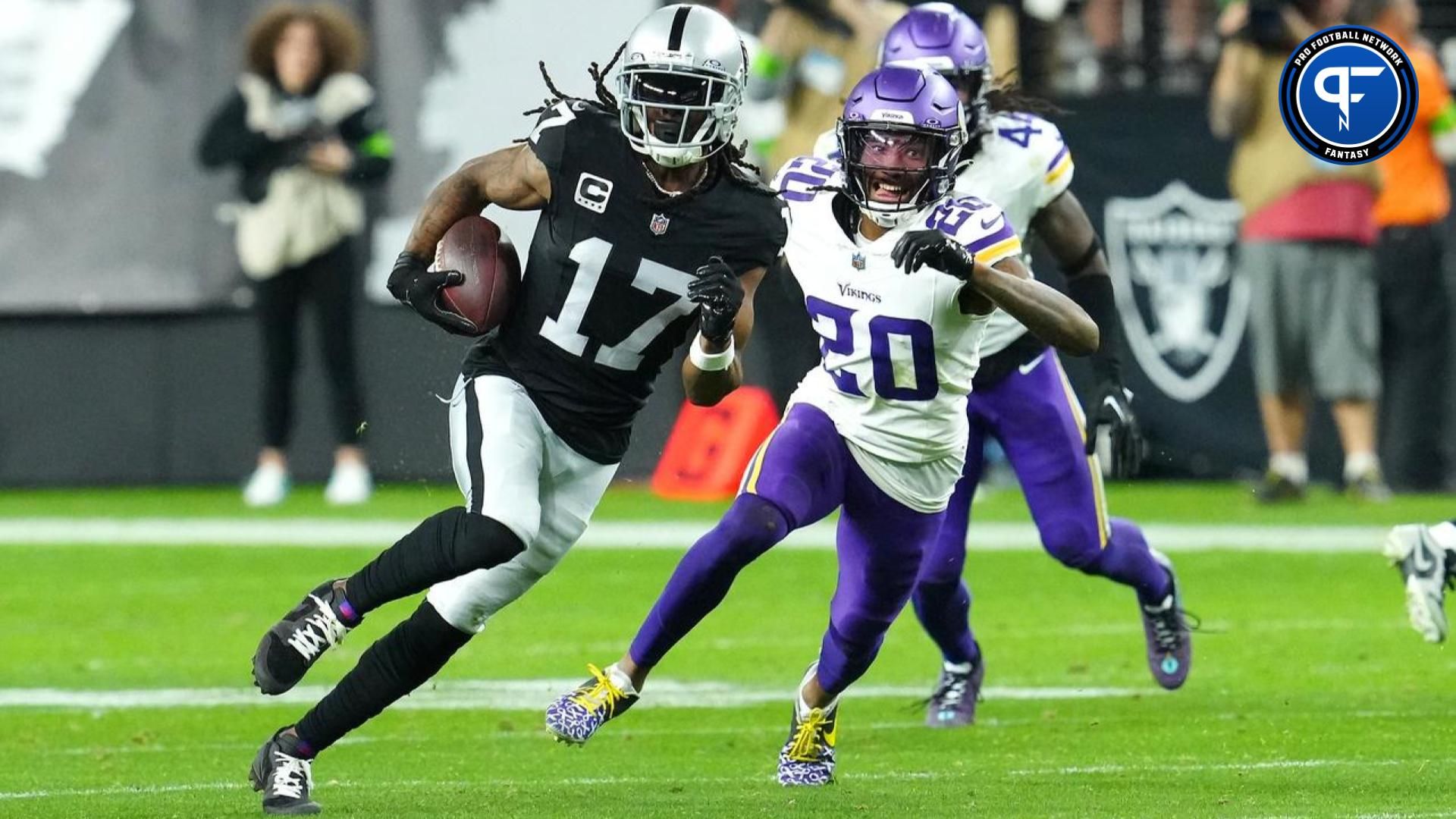 Dec 10, 2023; Paradise, Nevada, USA; Las Vegas Raiders wide receiver Davante Adams (17) gains yards ahead of Minnesota Vikings safety Jay Ward (20) during the final seconds of the fourth quarter at Allegiant Stadium.