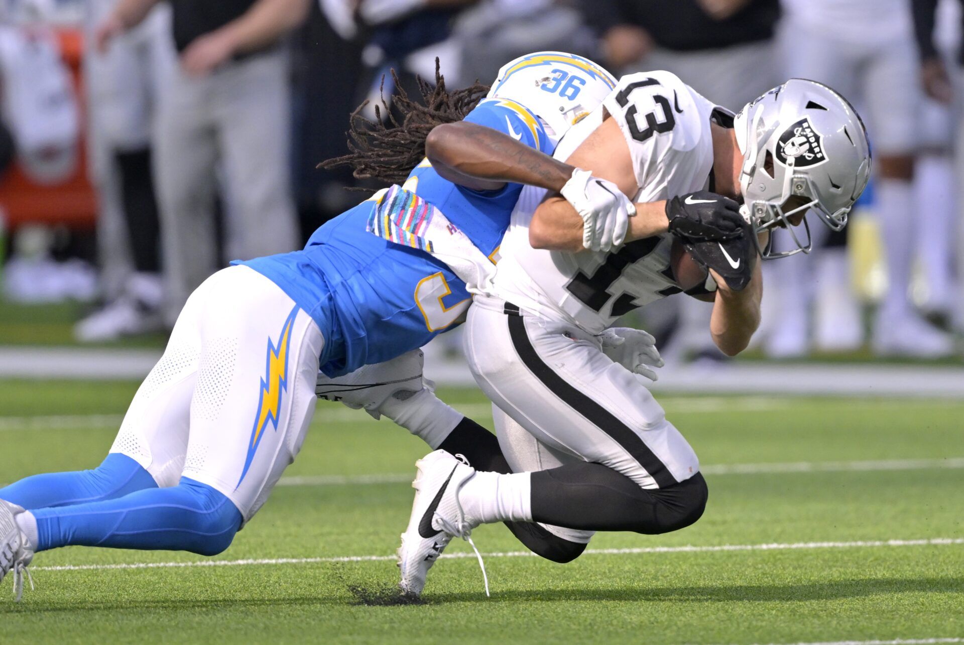 Las Vegas Raiders wide receiver Hunter Renfrow (13) is stopped by Los Angeles Chargers cornerback Asante Samuel Jr. (26).