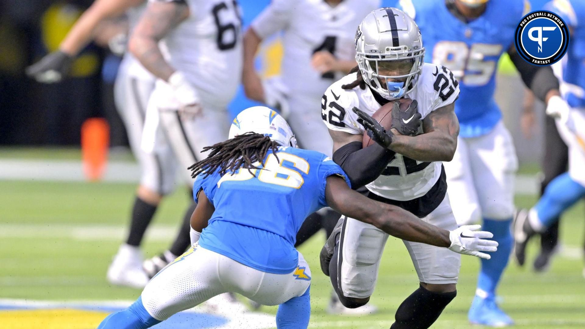 Las Vegas Raiders running back Ameer Abdullah (22) is stopped by Los Angeles Chargers cornerback Asante Samuel Jr. (26) after a gain in the second half at SoFi Stadium.