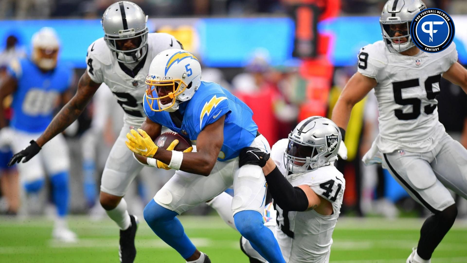 Los Angeles Chargers wide receiver Joshua Palmer (5) is brought down by Las Vegas Raiders linebacker Robert Spillane (41) during the first half at SoFi Stadium.