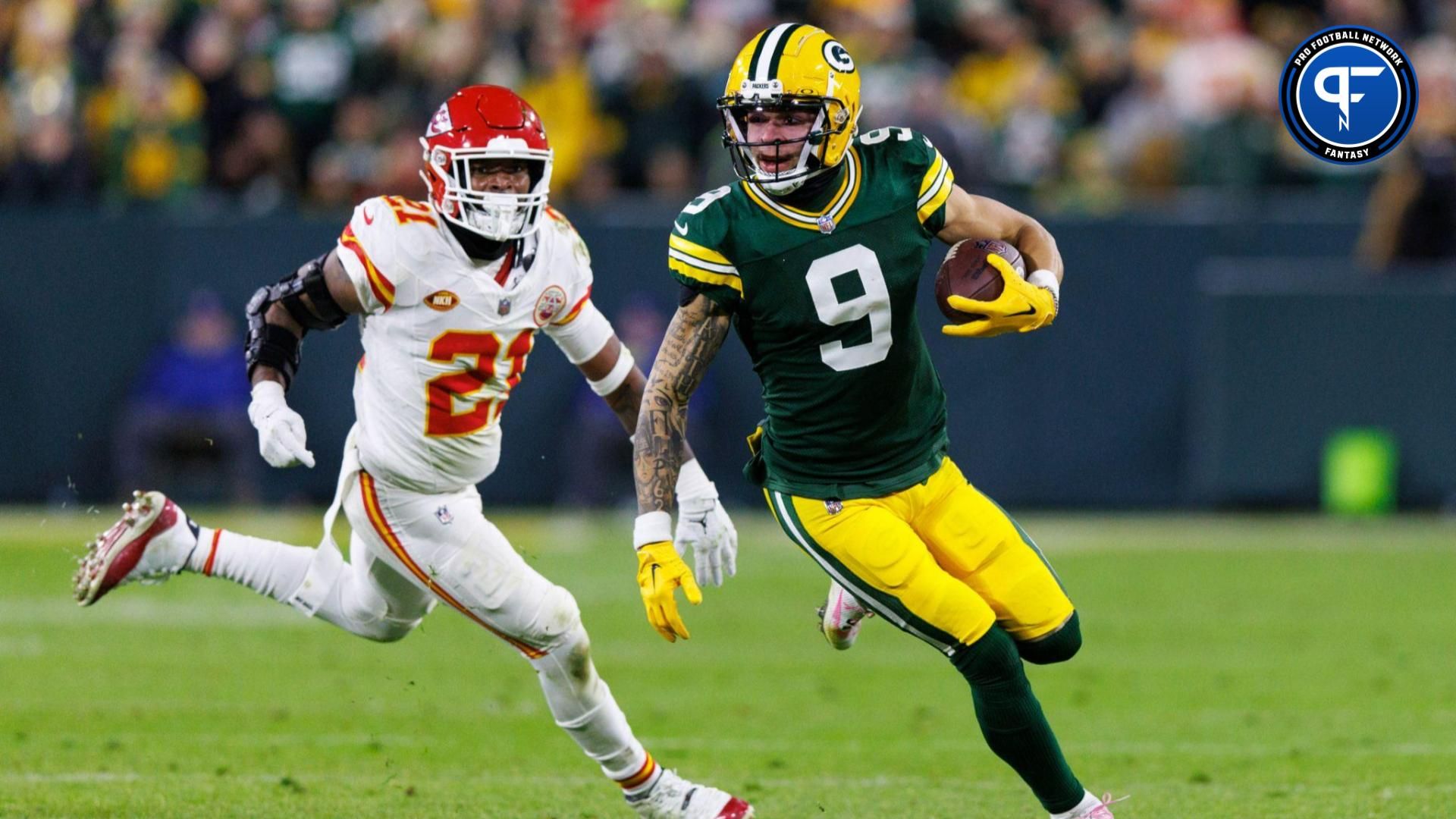 Green Bay Packers wide receiver Christian Watson (9) rushes with the football in front of Kansas City Chiefs safety Mike Edwards (21) during the fourth quarter at Lambeau Field.