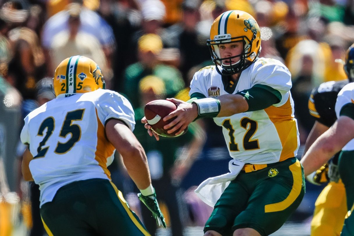 North Dakota State Bison quarterback Easton Stick (12) looks to hand the ball off to running back Chase Morlock (25) during the game against the Iowa Hawkeyes at Kinnick Stadium. North Dakota State won 23-21.