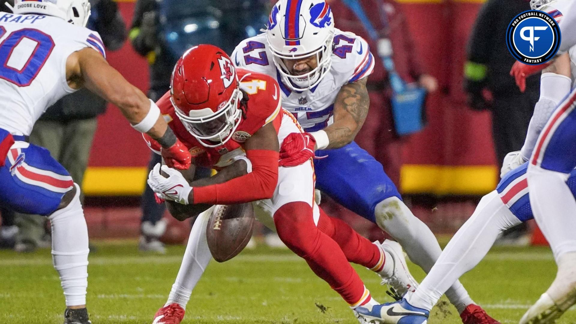 Kansas City Chiefs wide receiver Rashee Rice (4) looses the ball as Buffalo Bills cornerback Christian Benford (47) makes the tackle during the second half at GEHA Field at Arrowhead Stadium.