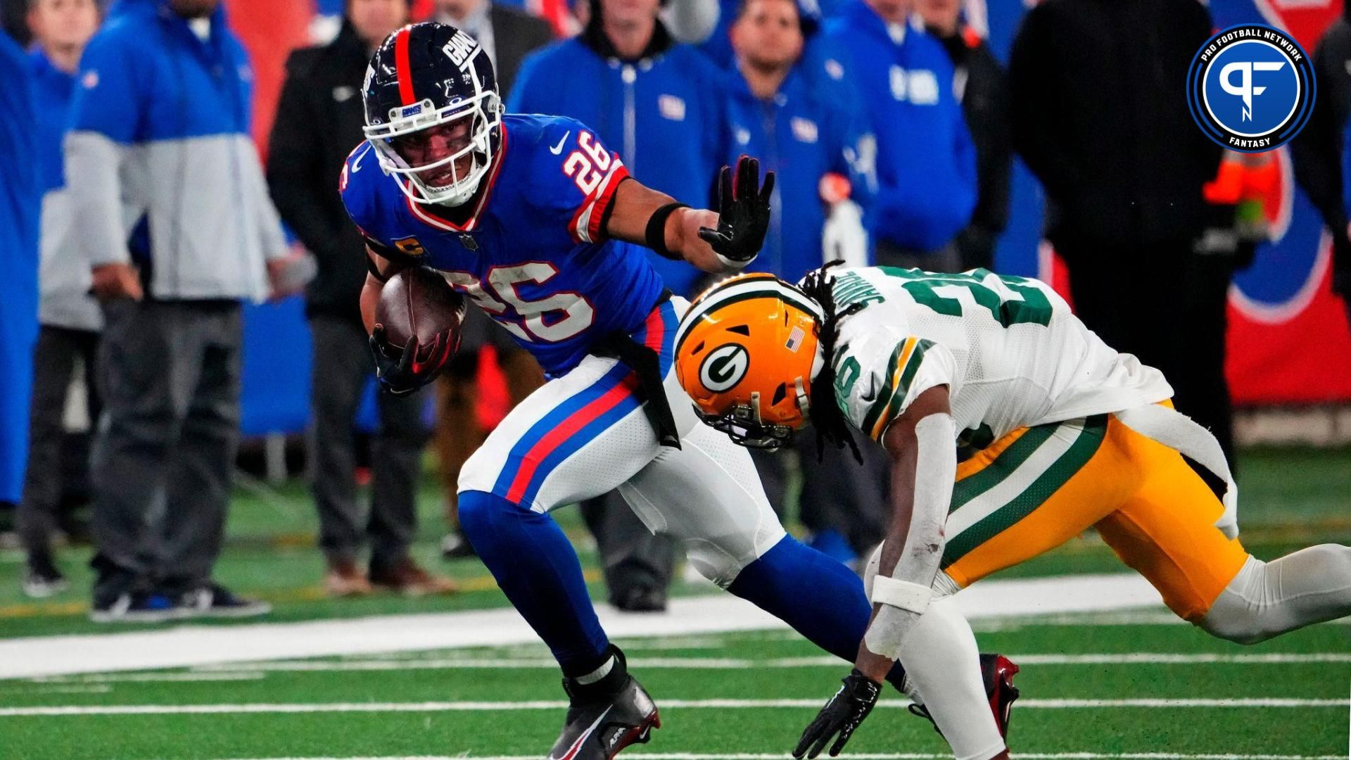 New York Giants running back Saquon Barkley (26) runs the ball against Green Bay Packers safety Darnell Savage (26) during the fourth quarter at MetLife Stadium.