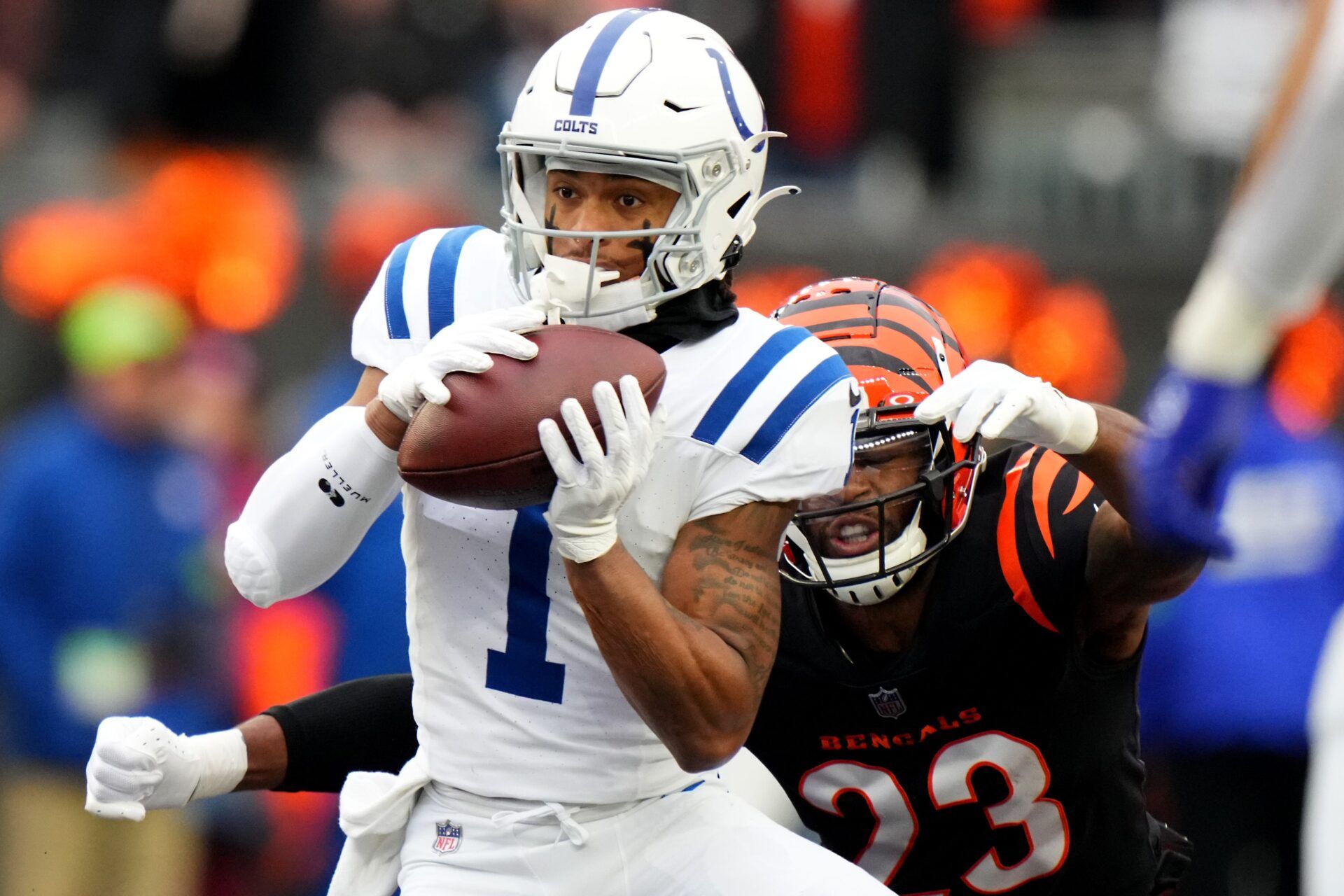 Indianapolis Colts wide receiver Josh Downs (1) completes a catch as Indianapolis Colts cornerback Kenny Moore II (23) defends in the first quarter during a Week 14 NFL game between the Indianapolis Colts and the Cincinnati Bengal