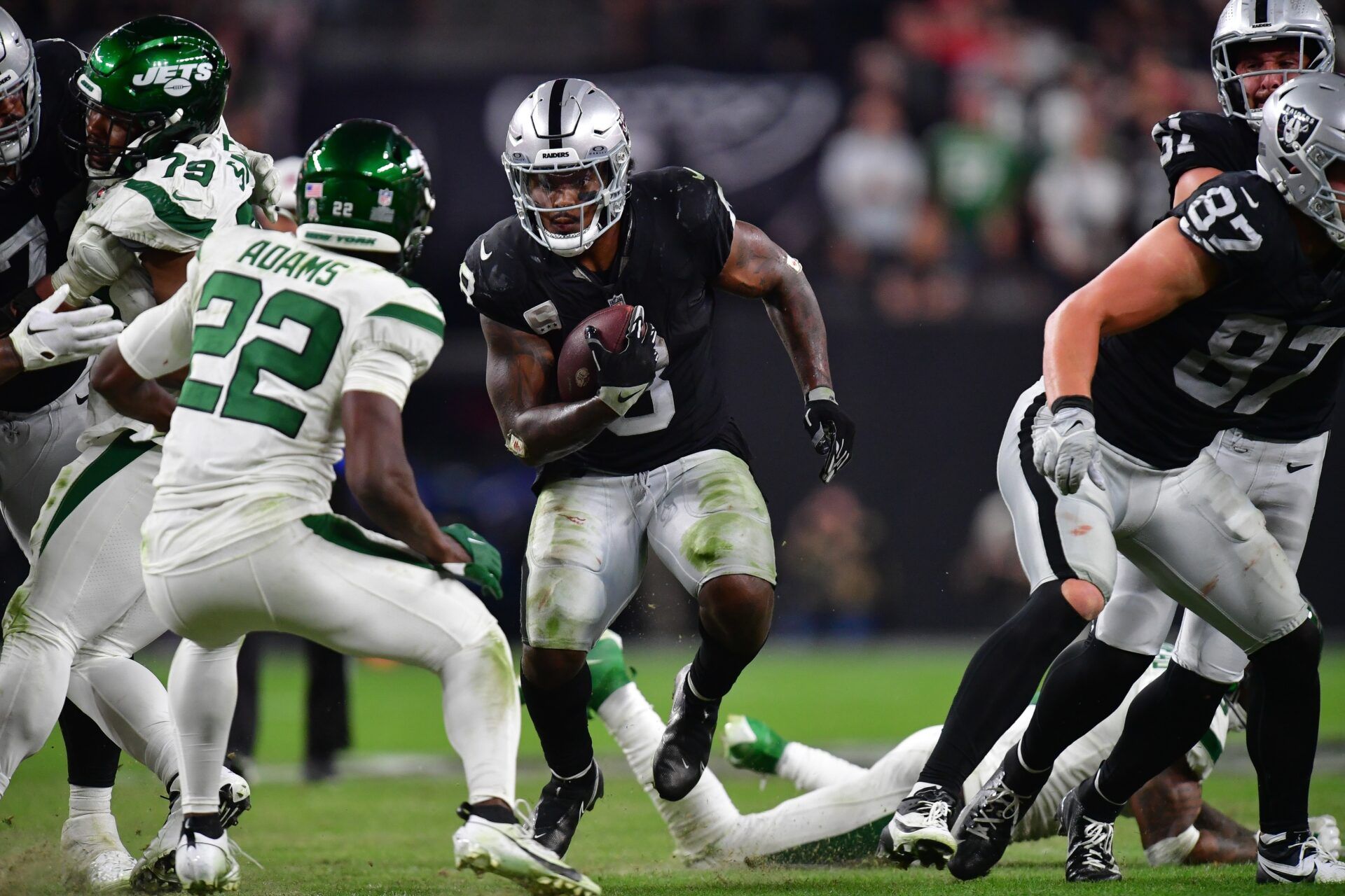 Las Vegas Raiders running back Josh Jacobs (8) runs the ball against New York Jets safety Tony Adams (22) during the second half at Allegiant Stadium.