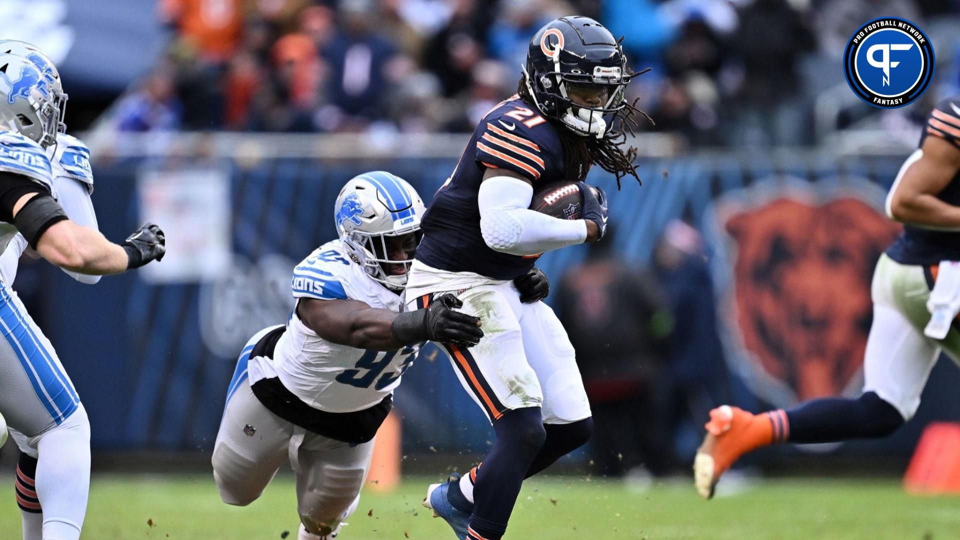 Detroit Lions defensive lineman Josh Paschal (93) hangs on to Chicago Bears running back D'Onta Foreman (21) to make the tackle in the second half at Soldier Field.