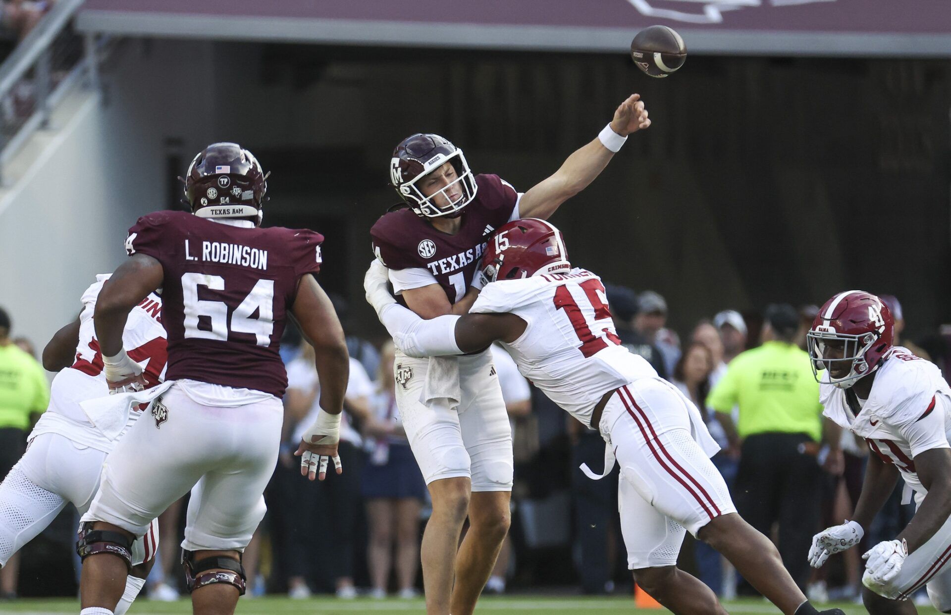 Texas A&M Aggies quarterback Max Johnson (14) attempts a pass as Alabama Crimson Tide linebacker Dallas Turner (15) applies defensive pressure during the fourth quarter at Kyle Field.