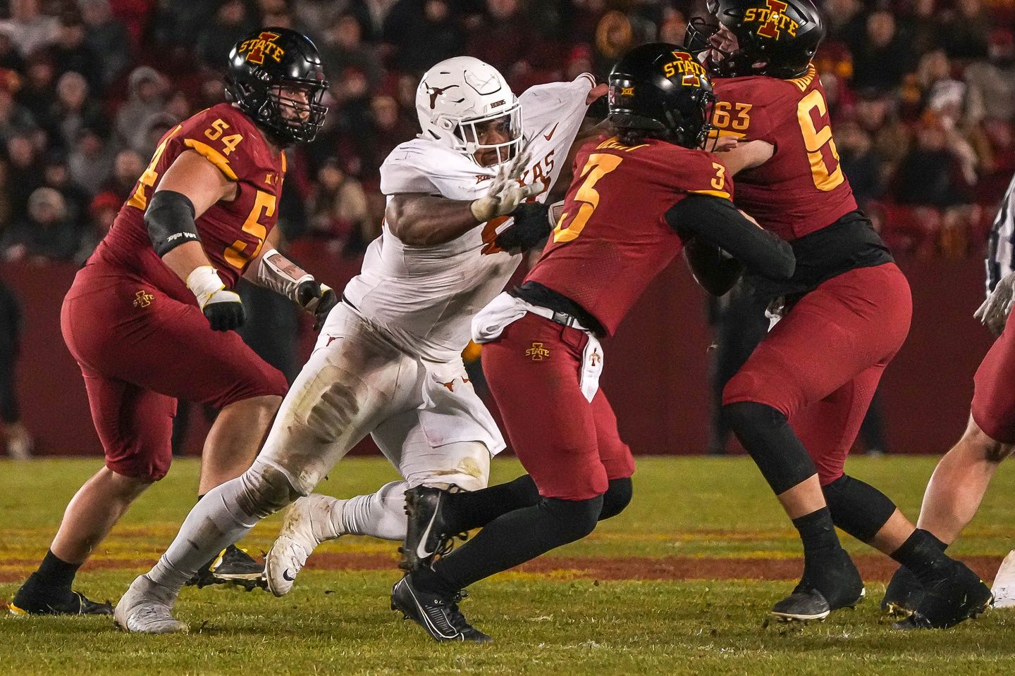 Texas Longhorns defensive lineman Byron Murphy II (90) breaks through the Iowa State Cyclones offensive line to sack quarterback Rocco Becht (3) during the game against the Iowa State Cyclones at Jack Trice Stadium.