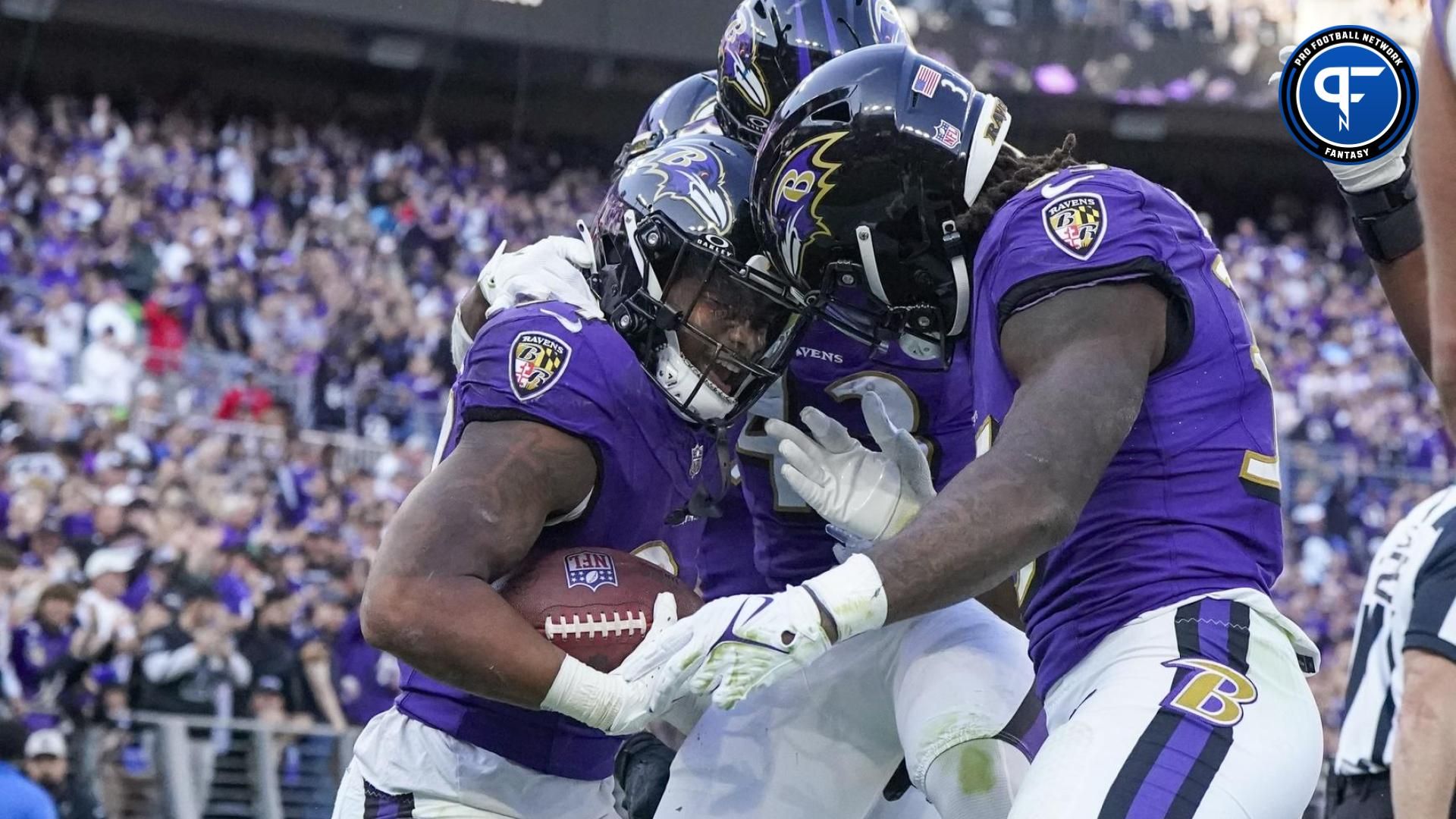 Baltimore Ravens running back Keaton Mitchell (34) celebrates his touchdown against the Seattle Seahawks with running back Justice Hill (43) and running back Gus Edwards (35) during the third quarter at M&T Bank Stadium.