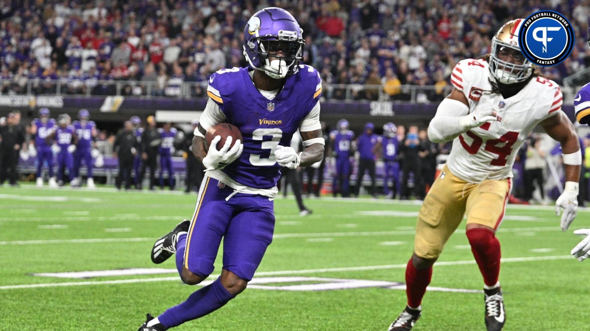 Minnesota Vikings wide receiver Jordan Addison (3) runs with the ball as San Francisco 49ers linebacker Fred Warner (54) pursues during the game at U.S. Bank Stadium.