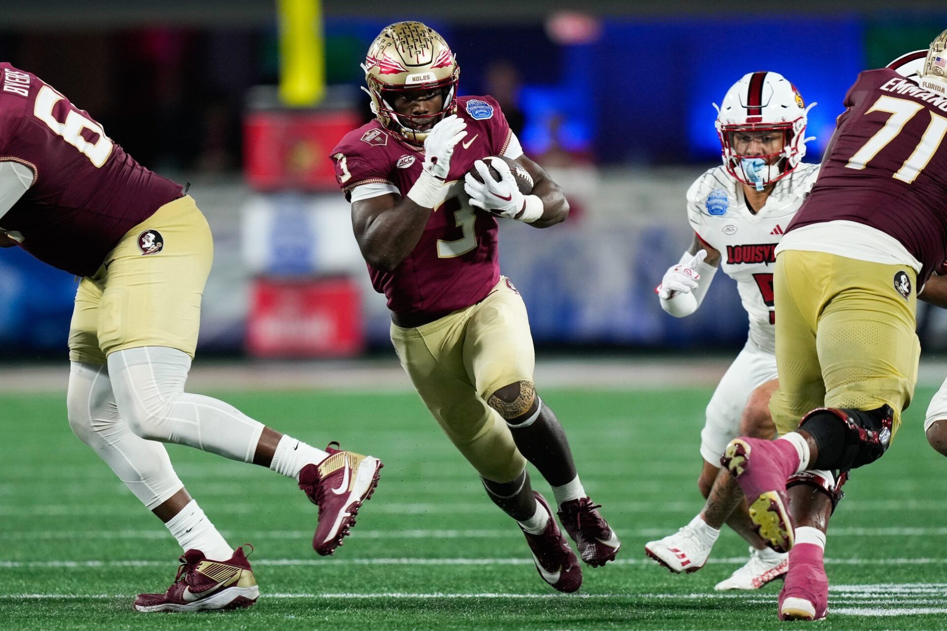 Florida State Seminoles running back Trey Benson (3) runs the ball against the Louisville Cardinals during the fourth quarter at Bank of America Stadium.