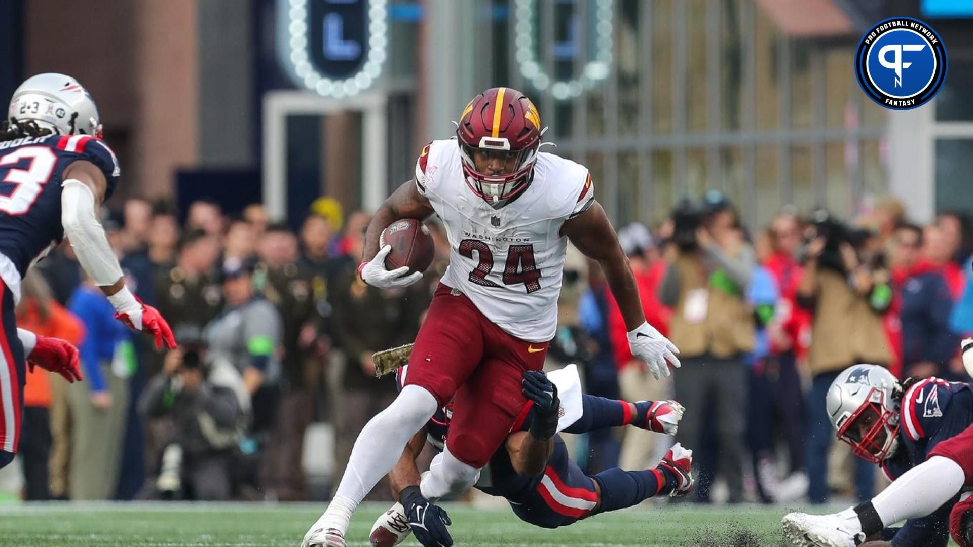 Washington Commanders running back Antonio Gibson (24) runs the ball during the first half against the New England Patriots at Gillette Stadium.