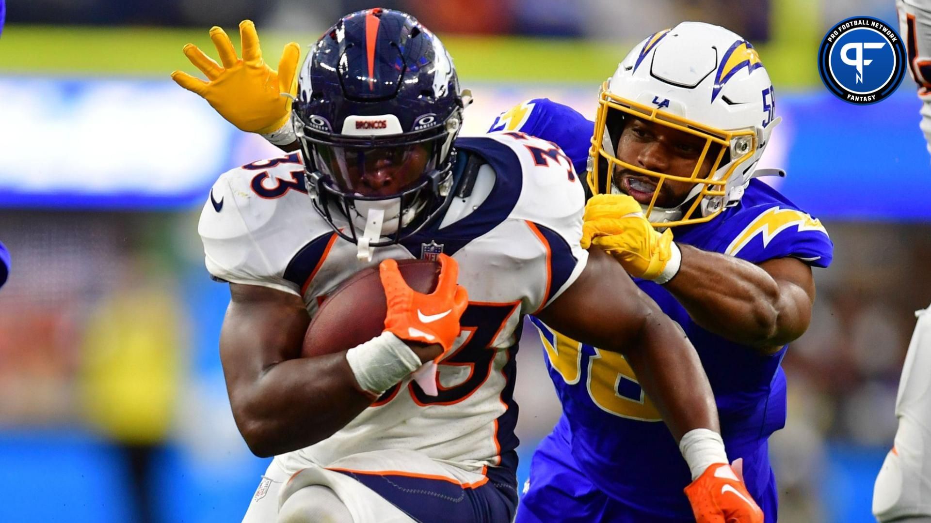 Denver Broncos running back Javonte Williams (33) runs the ball against Los Angeles Chargers linebacker Justin Hollins (58) during the second half at SoFi Stadium.