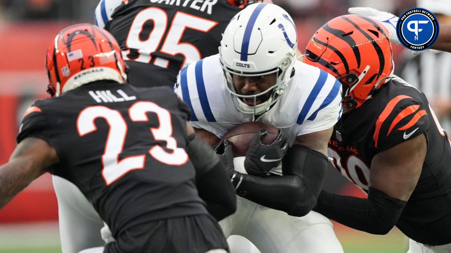 Indianapolis Colts running back Zack Moss (21) tries to move pass Cincinnati Bengals defenders Sunday, Dec. 10, 2023, during a game against the Cincinnati Bengals at Paycor Stadium in Cincinnati.
