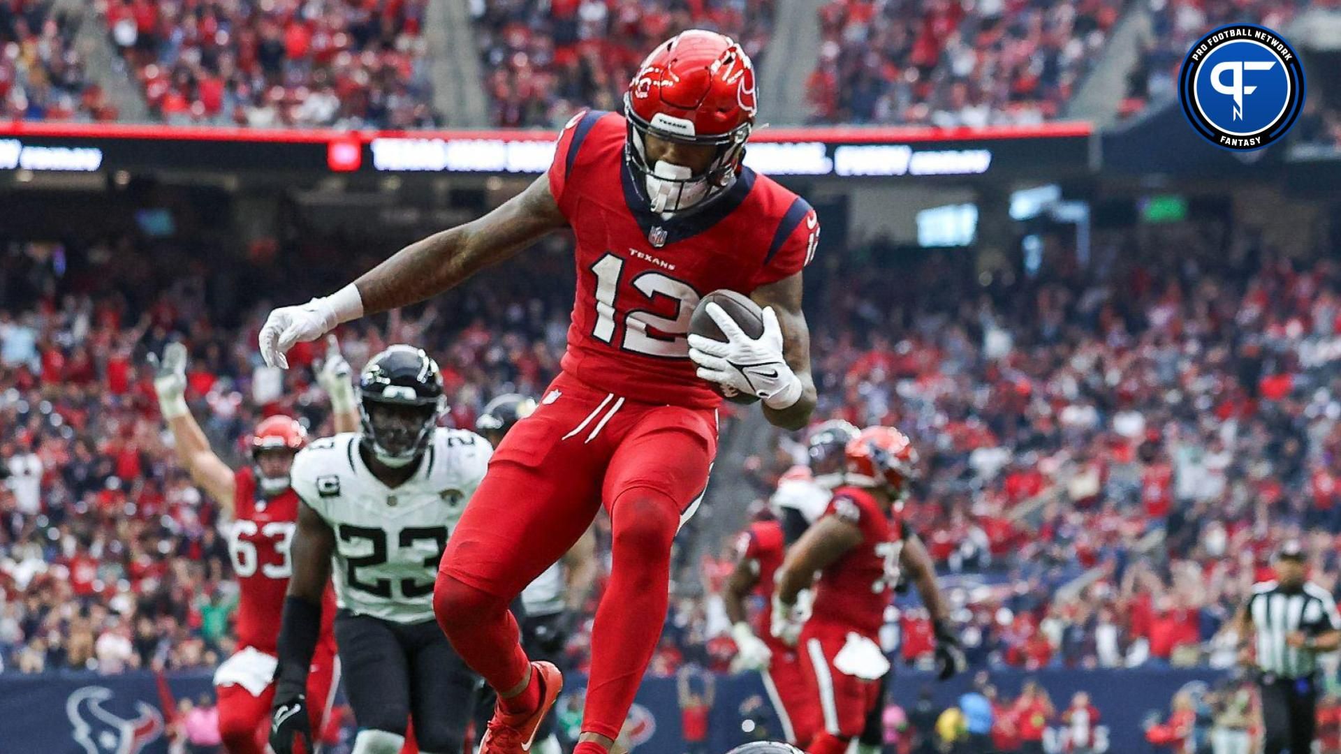 Houston Texans wide receiver Nico Collins (12) leaps into the end zone to score a touchdown during the fourth quarter against the Jacksonville Jaguars at NRG Stadium.