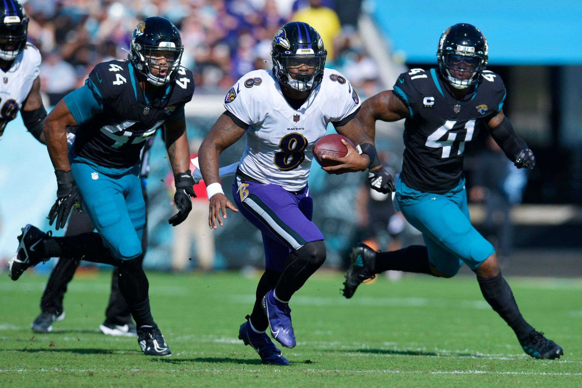 Jacksonville Jaguars linebacker Travon Walker (44) and linebacker Josh Allen (41) try to run down Baltimore Ravens quarterback Lamar Jackson (8) during early fourth quarter action. Offsetting penalties negated the play.