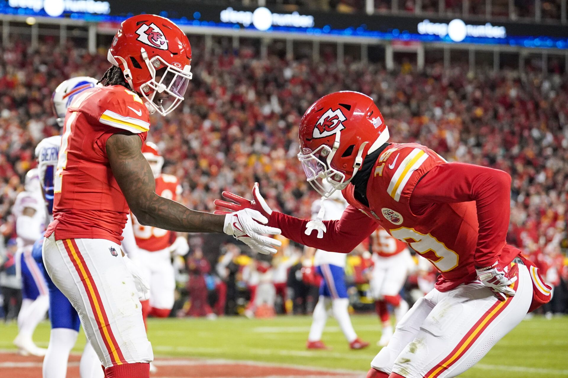 Kansas City Chiefs wide receiver Rashee Rice (4) celebrates with wide receiver Kadarius Toney (19) after scoring against the Buffalo Bills during the first half at GEHA Field at Arrowhead Stadium.