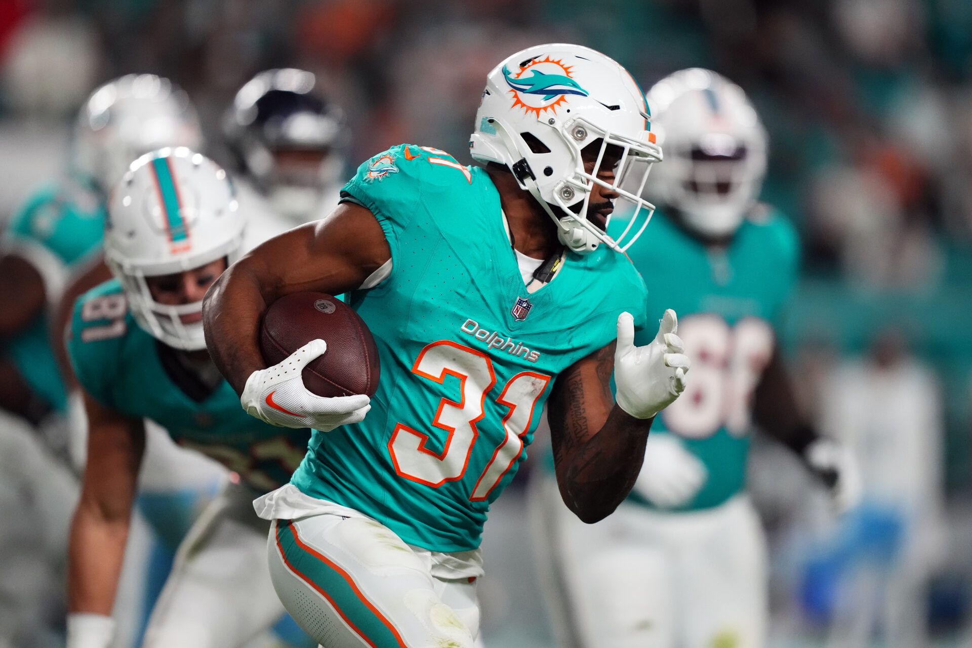 Dec 11, 2023; Miami Gardens, Florida, USA; Miami Dolphins running back Raheem Mostert (31) runs the ball against the Tennessee Titans during the second half at Hard Rock Stadium. Mandatory Credit: Jasen Vinlove-USA TODAY Sports