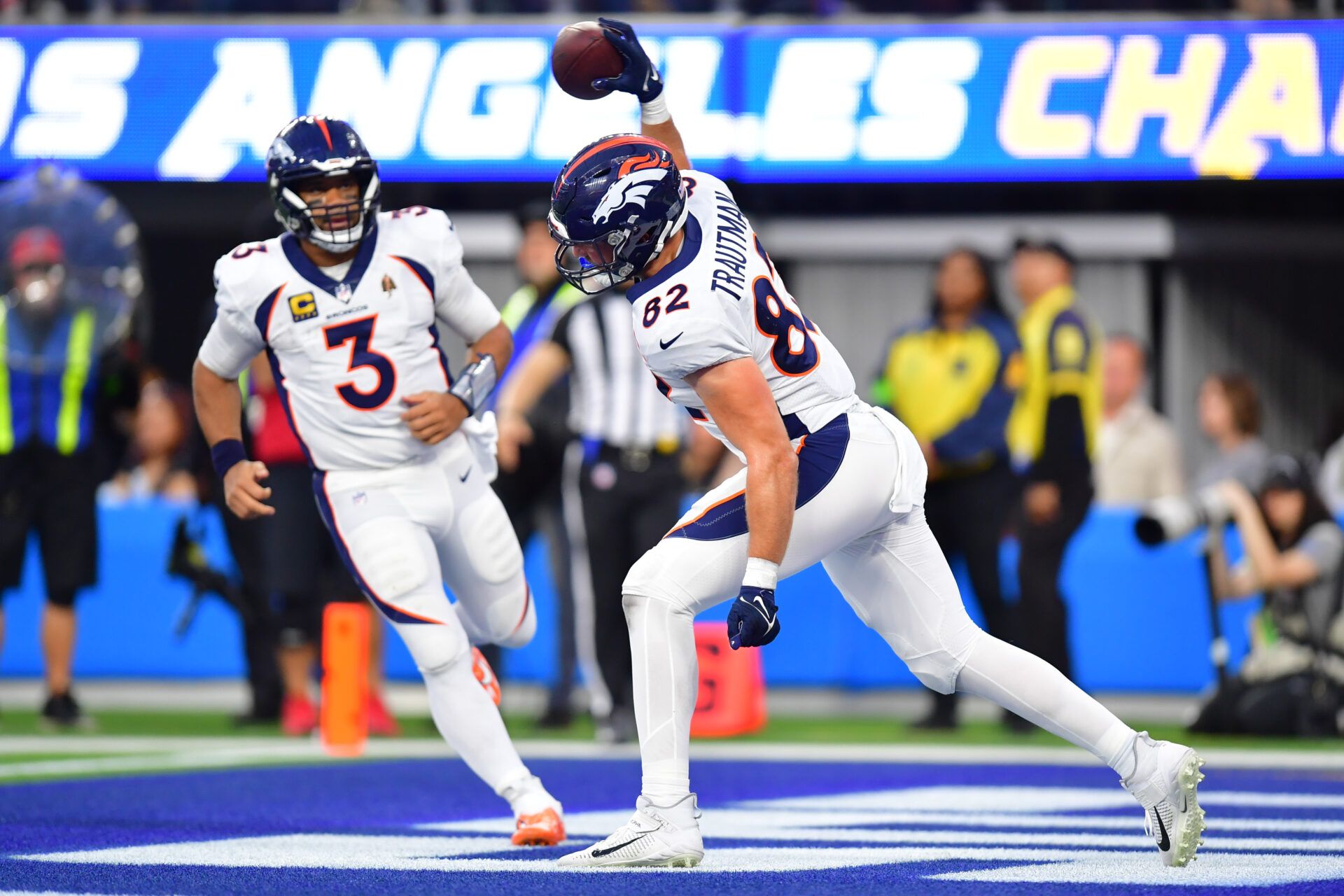 Denver Broncos tight end Adam Trautman (82) celebrates his touchdown scored against the Los Angeles Chargers with quarterback Russell Wilson (3) during the second half at SoFi Stadium.