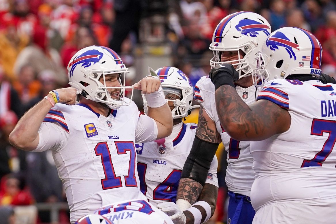 Buffalo Bills quarterback Josh Allen (17) celebrates with team mates after a score against the Kansas City Chiefs during the first half at GEHA Field at Arrowhead Stadium.