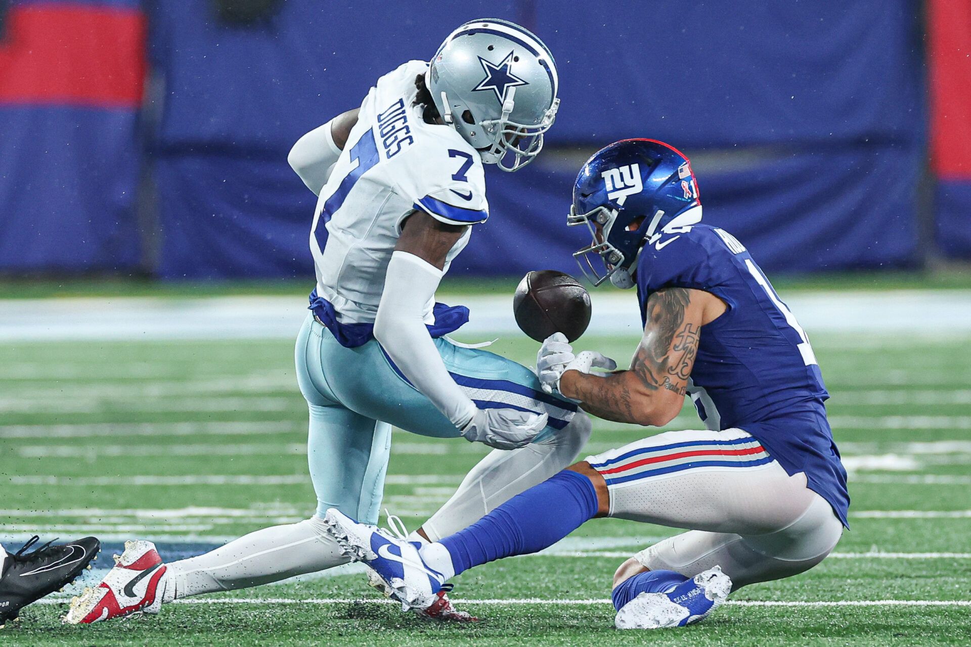 Dallas Cowboys cornerback Trevon Diggs (7) forces a fumble by New York Giants wide receiver Isaiah Hodgins (18) during the second half at MetLife Stadium.