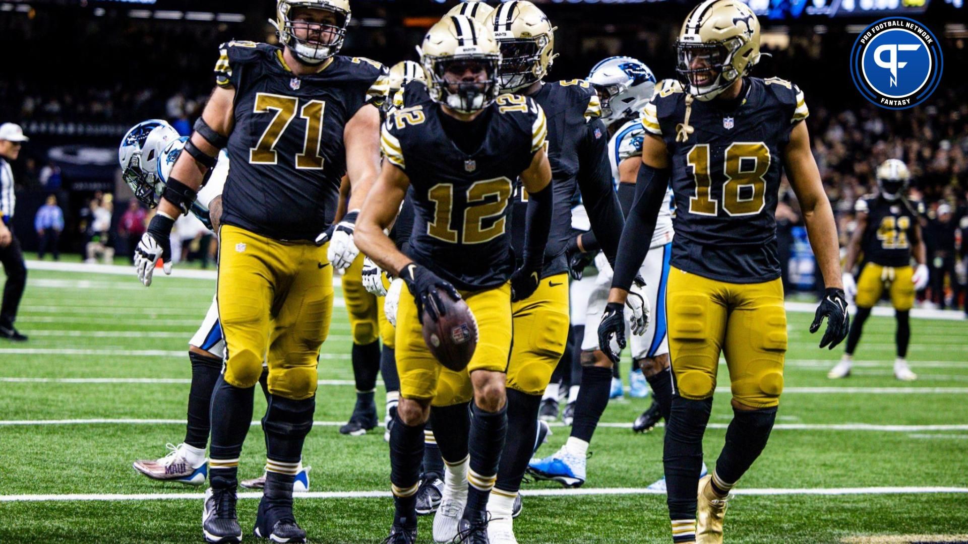 New Orleans Saints wide receiver Chris Olave (12) reacts to making a touchdown against Carolina Panthers safety Vonn Bell (24) during the second half at the Caesars Superdome.