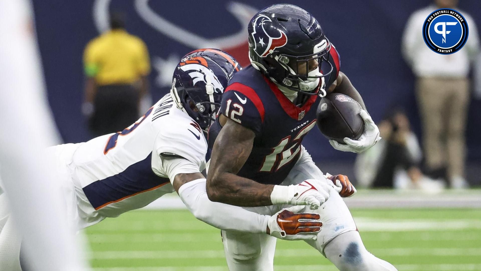 Houston Texans wide receiver Nico Collins (12) makes a reception as Denver Broncos cornerback Pat Surtain II (2) defends during the fourth quarter at NRG Stadium.