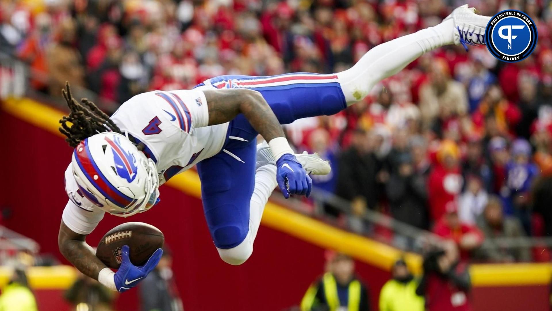 Buffalo Bills running back James Cook (4) dives into the end zone for a touchdown during the first half against the Kansas City Chiefs at GEHA Field at Arrowhead Stadium.