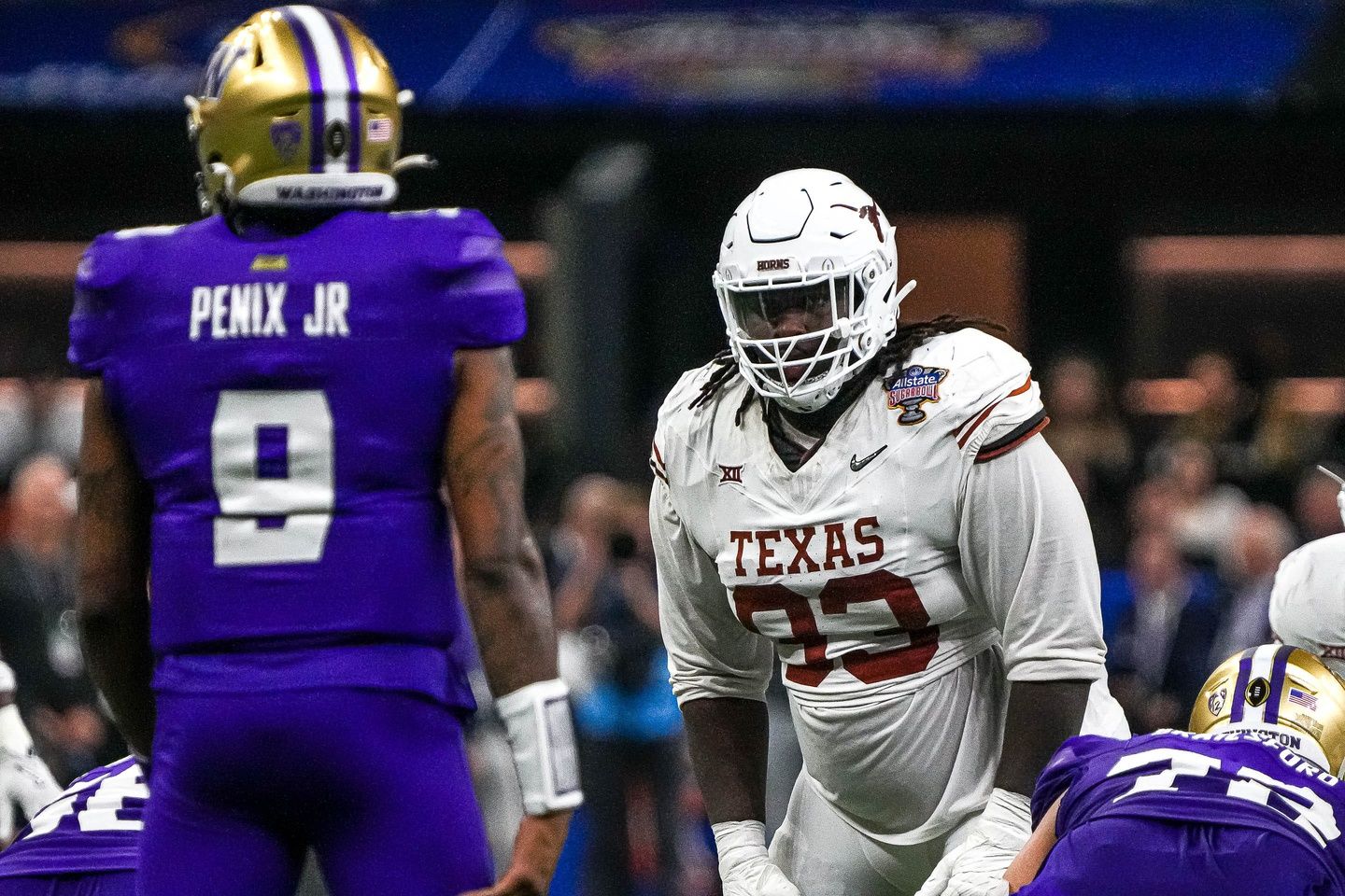 Texas Longhorns DT T'Vondre Sweat (93) stares down Washington Huskies QB Michael Penix Jr. (9).