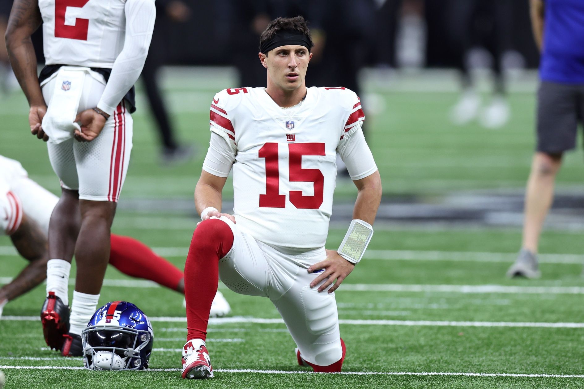 New York Giants QB Tommy DeVito (15) stretches before the game against the New Orleans Saints.