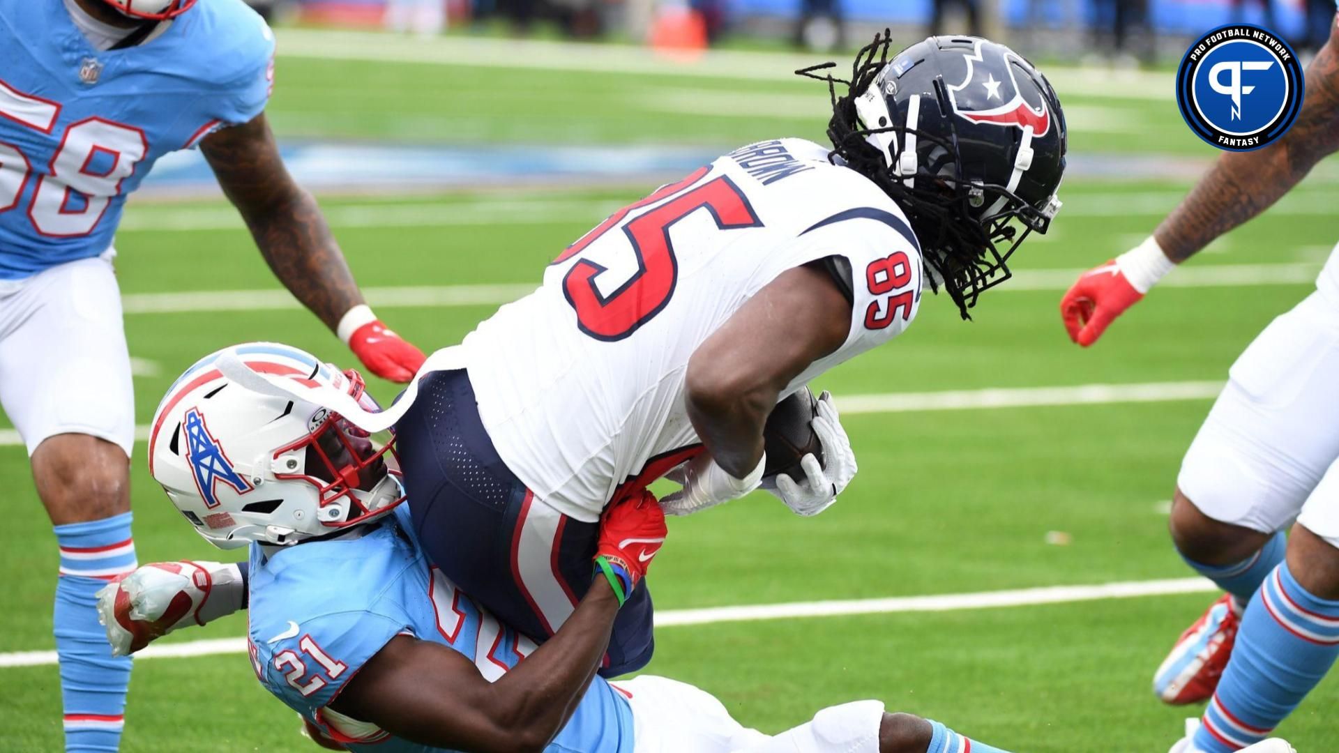 Houston Texans wide receiver Noah Brown (85) is tackled by Tennessee Titans cornerback Roger McCreary (21) after a reception during the first half at Nissan Stadium.