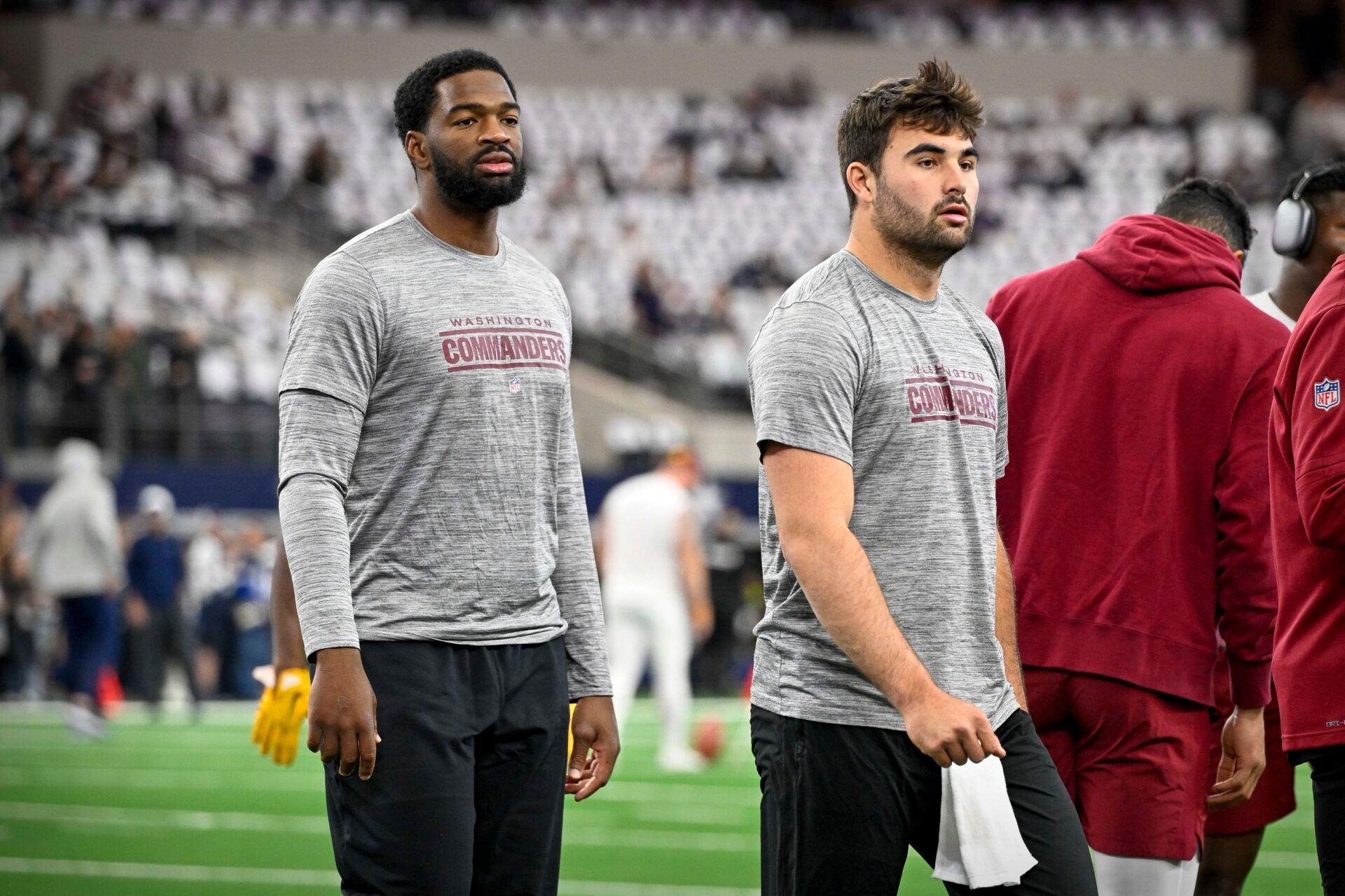 Washington Commanders quarterback Jacoby Brissett (left) and quarterback Sam Howell (right) warm up before the game between the Dallas Cowboys and the Washington Commanders at AT&T Stadium.