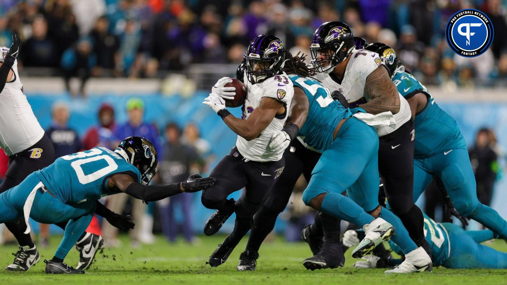 Baltimore Ravens running back Justice Hill (43) runs with the ballagainst the Jacksonville Jaguars in the second quarter at EverBank Stadium.