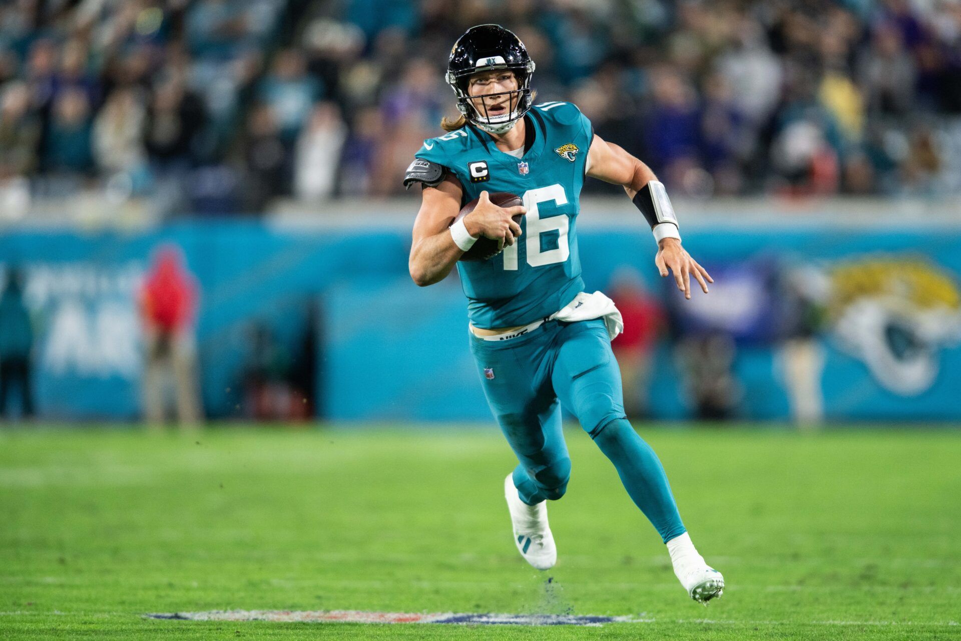 Jacksonville Jaguars QB Trevor Lawrence (16) runs with the ball against the Baltimore Ravens.