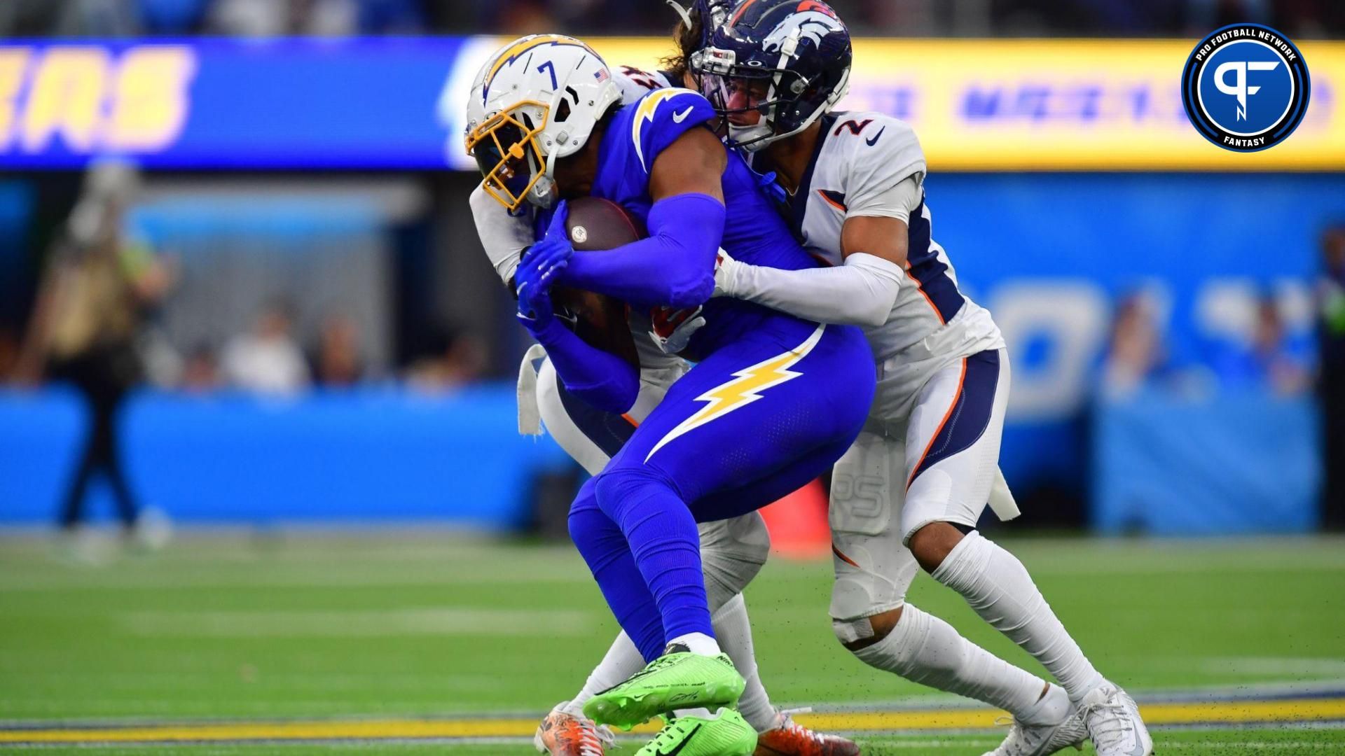 Los Angeles Chargers TE Gerald Everett (7) is tackled by a pair of Denver Broncos defenders.