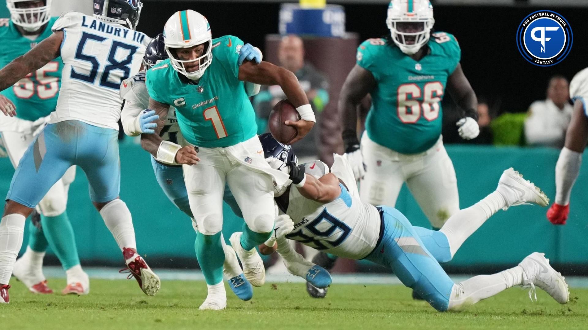 Miami Dolphins quarterback Tua Tagovailoa (1) gets taken down by Tennessee Titans safety Matthew Jackson (39) during the second half of an NFL game at Hard Rock Stadium in Miami Gardens, Dec. 11, 2023.