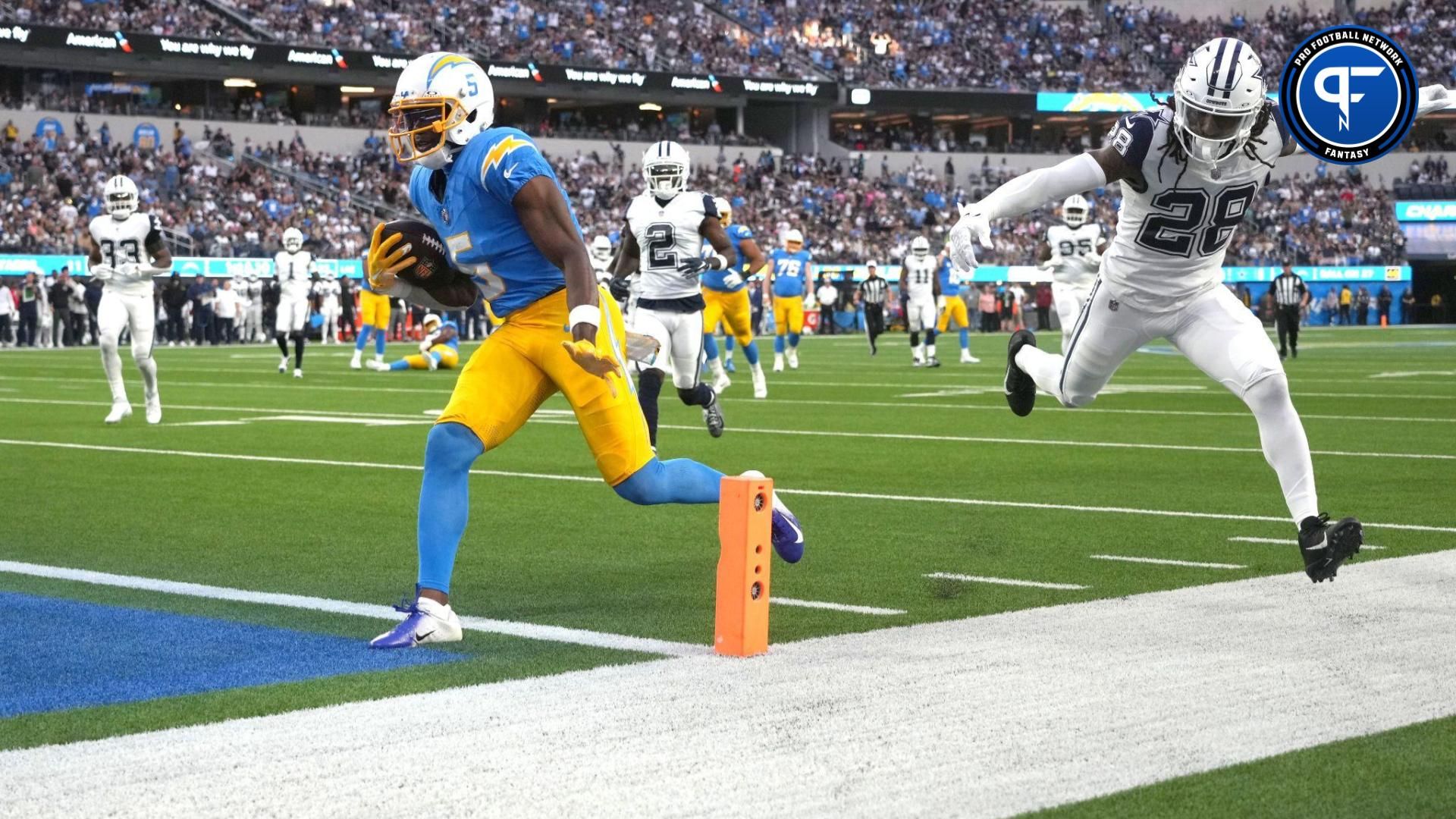 Los Angeles Chargers wide receiver Joshua Palmer (5) carries the ball against Dallas Cowboys safety Malik Hooker (28) in the first half at SoFi Stadium.