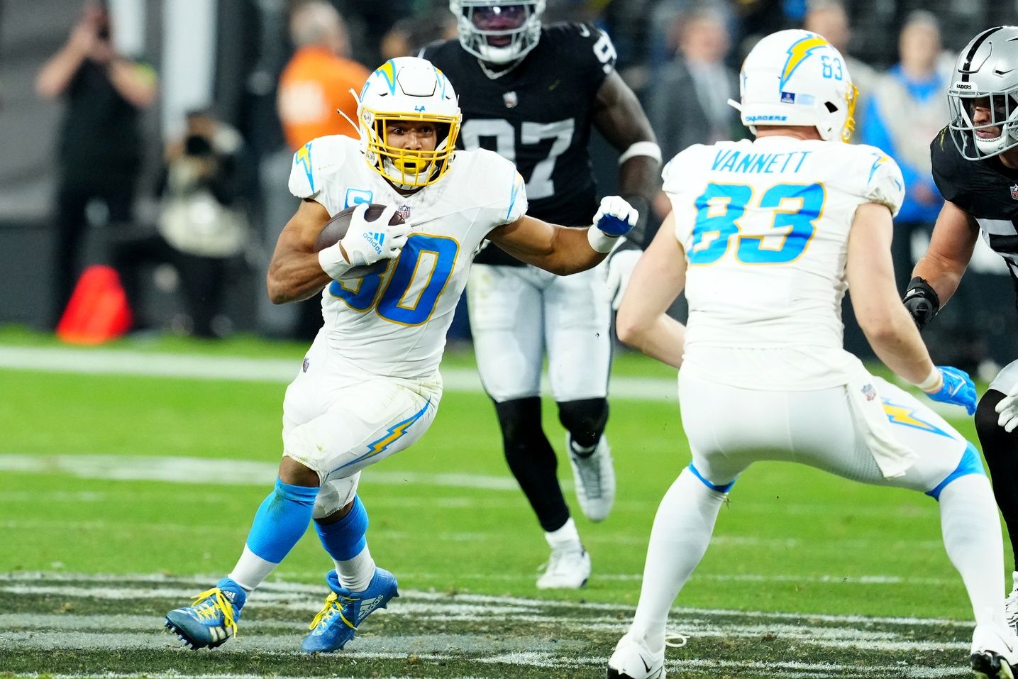 Los Angeles Chargers running back Austin Ekeler (30) runs against the Las Vegas Raiders in the fourth quarter at Allegiant Stadium.