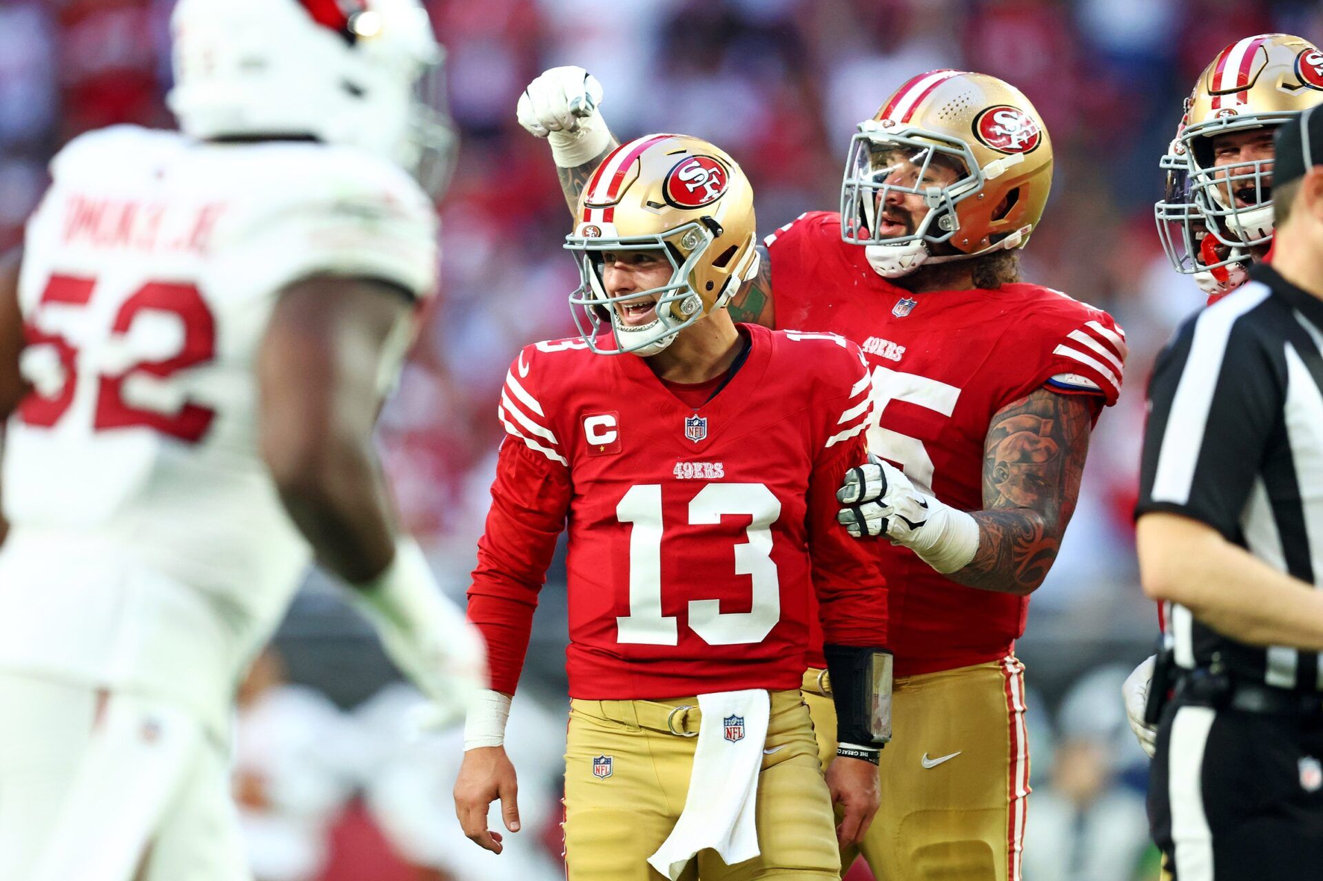 San Francisco 49ers QB Brock Purdy (13) celebrates after a play with a teammate against the Arizona Cardinals.