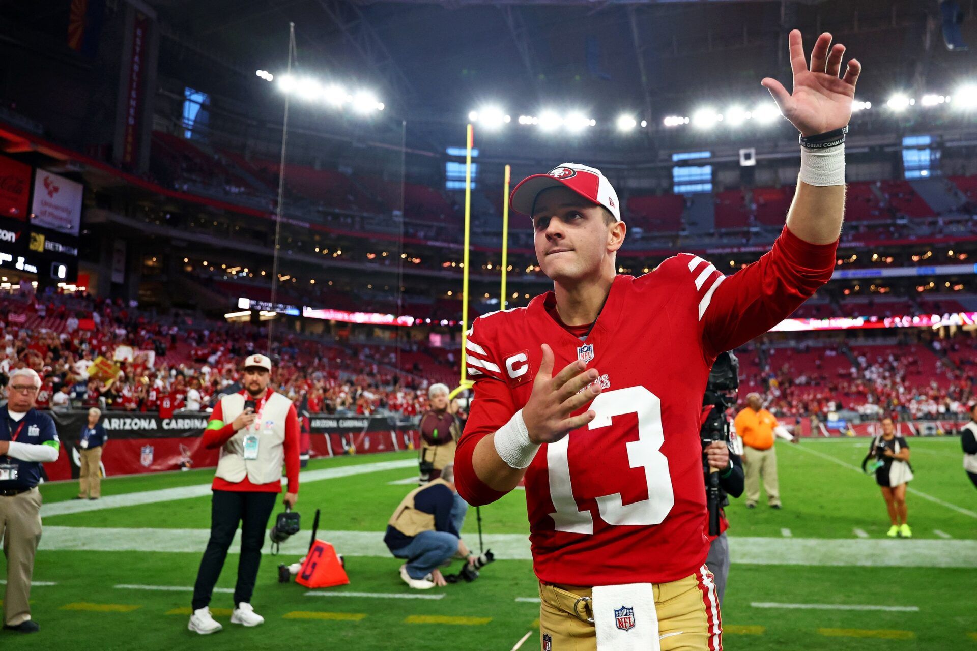 San Francisco 49ers quarterback Brock Purdy (13) celebrates after beating the Arizona Cardinals at State Farm Stadium.