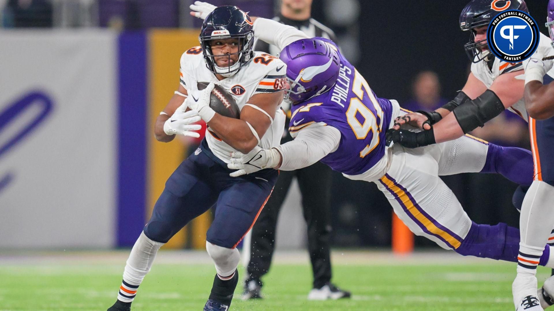 Chicago Bears running back Roschon Johnson (23) runs with the ball against the Minnesota Vikings defensive tackle Harrison Phillips (97) in the third quarter at U.S. Bank Stadium.