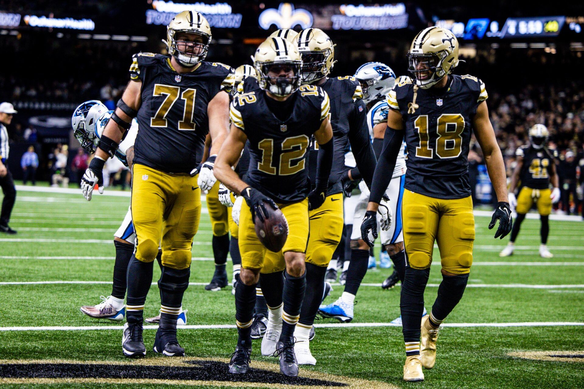 New Orleans Saints wide receiver Chris Olave (12) reacts to making a touchdown against Carolina Panthers safety Vonn Bell (24) during the second half at the Caesars Superdome.