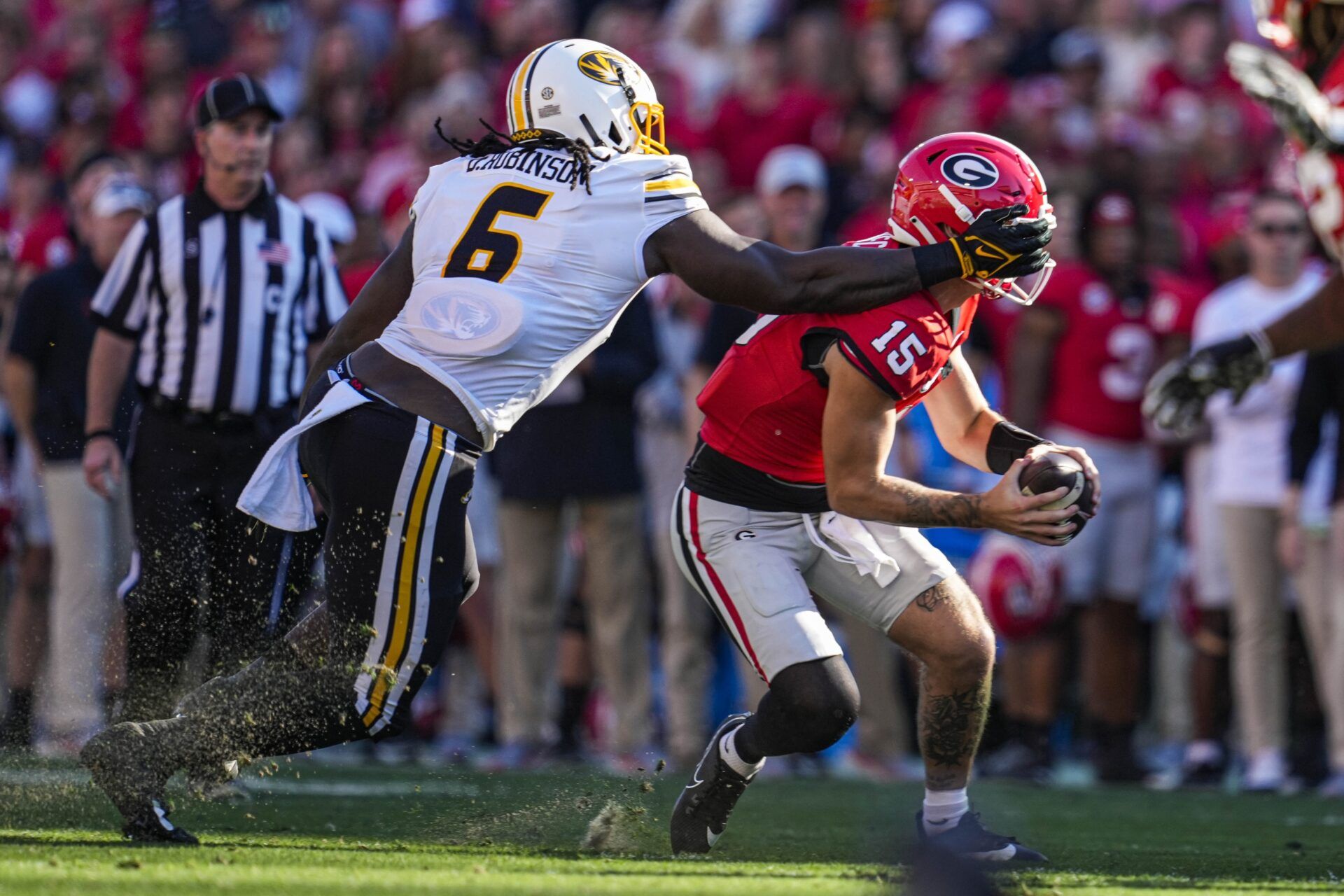 Georgia Bulldogs quarterback Carson Beck (15) is sacked by Missouri Tigers defensive lineman Darius Robinson (6) during the first half at Sanford Stadium.